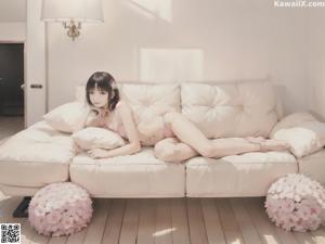 A woman laying on a white couch in a room.