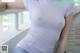 A woman in a purple shirt is leaning against a railing.