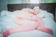 A woman in pink stockings laying on a bed.